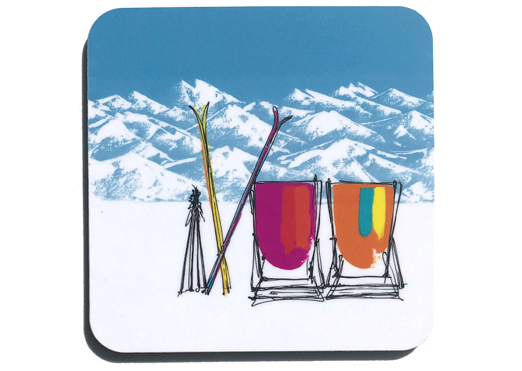 Colourful art coaster of 2 pink and orange deckchairs in the snow with crossed skis, poles and mountain backdrop by artist Hannah van Bergen