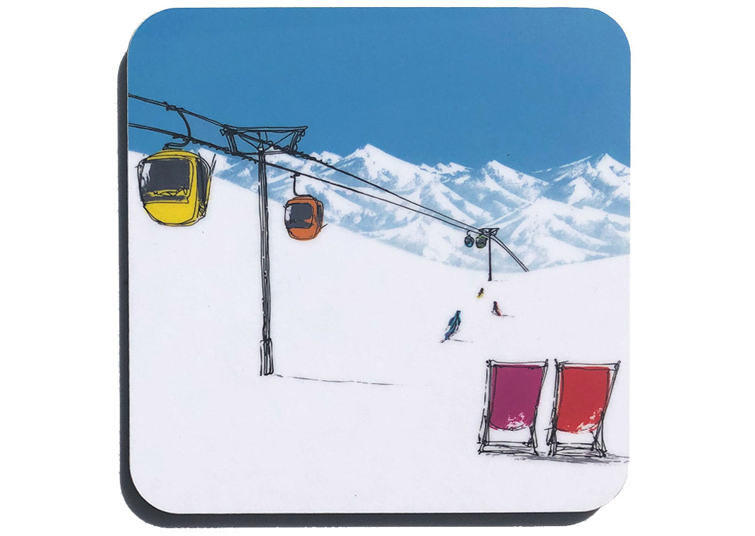 Art coaster of 2 deckchairs in the snow with skiers, cable car and mountain backdrop by artist Hannah van Bergen