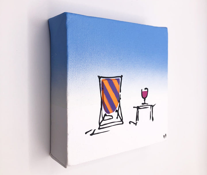 Original textured mini canvas painting of a colourful deckchair in the snow with a drink and blue sky by artist Hannah van Bergen