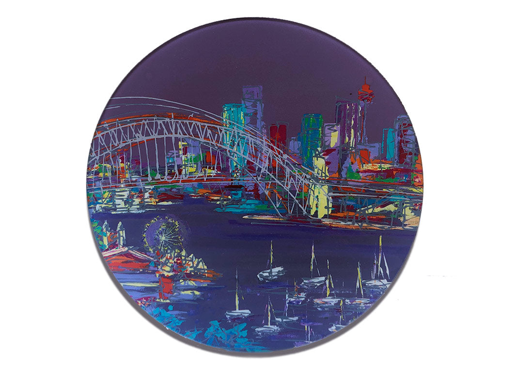 Round glass platter / worktop saver with artwork of Sydney Harbour Bridge with skyline in background and funfair and boats at the fore on a purple background by artist Hannah van Bergen