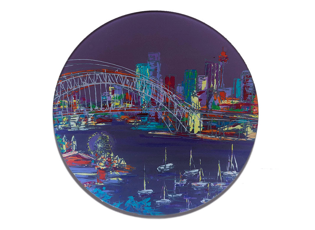 Round glass platter / worktop saver with artwork of Sydney Harbour Bridge with skyline in background and funfair and boats at the fore on a purple background by artist Hannah van Bergen