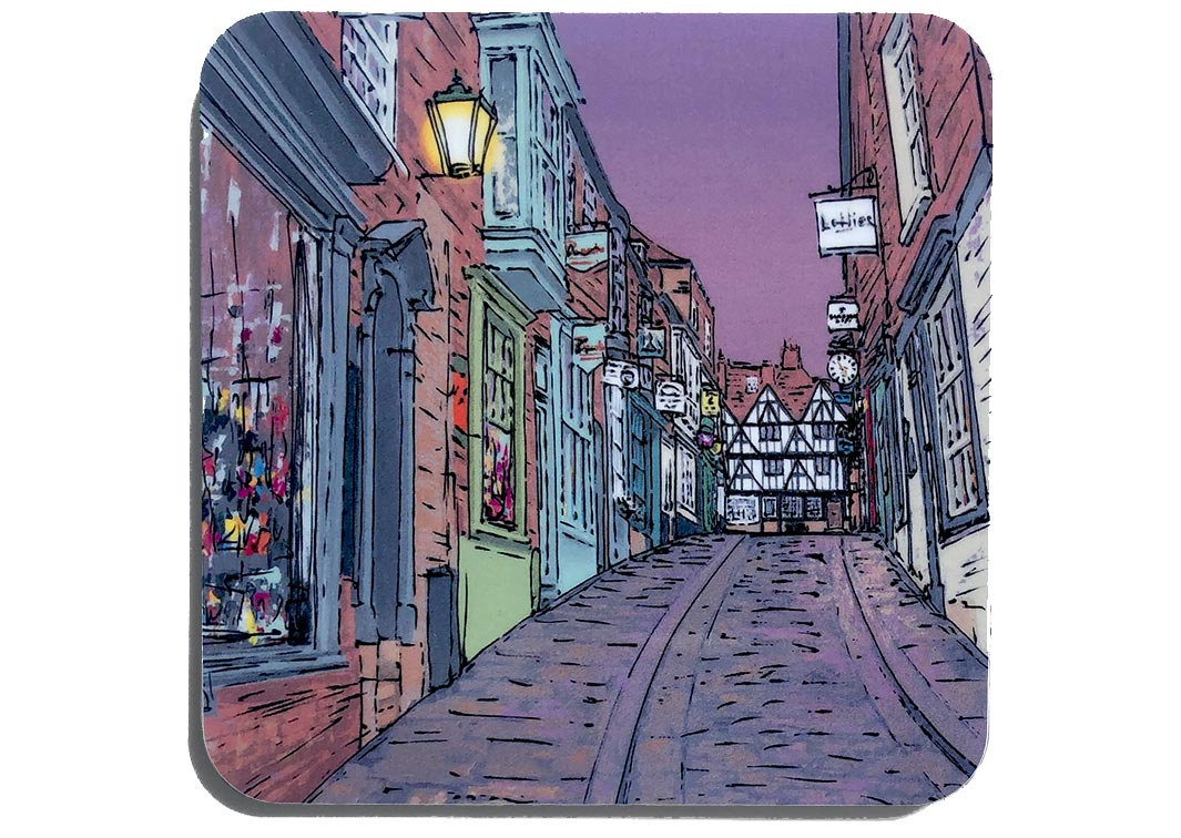 Art coaster of Lincoln Steep Hill at dusk with street lamps and independent shops by artist Hannah van Bergen 