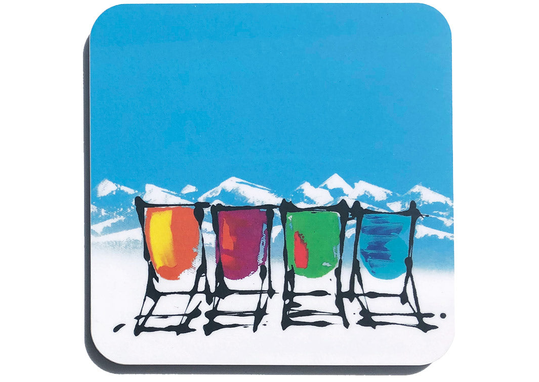 Colourful art coaster of 4 deckchairs in the snow with blue sky and mountain backdrop by artist Hannah van Bergen