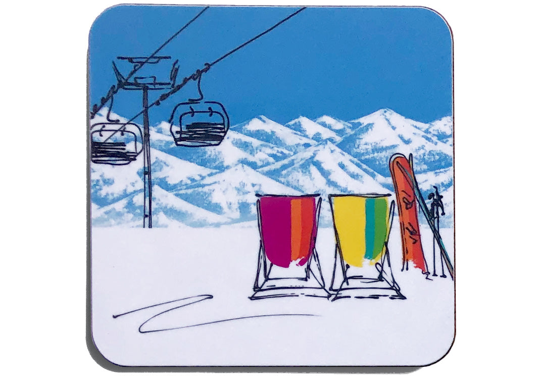 Art coaster of 2 deckchairs in the snow with snowboard and skis, ski lift and mountain backdrop by artist Hannah van Bergen