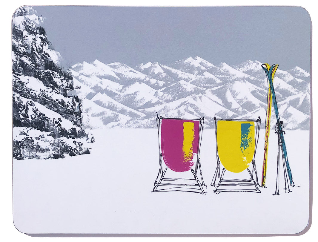 Rectangular melamine chopping board featuring 2 deckchairs in the snow with skis and mountains on grey sky background by artist Hannah van Bergen