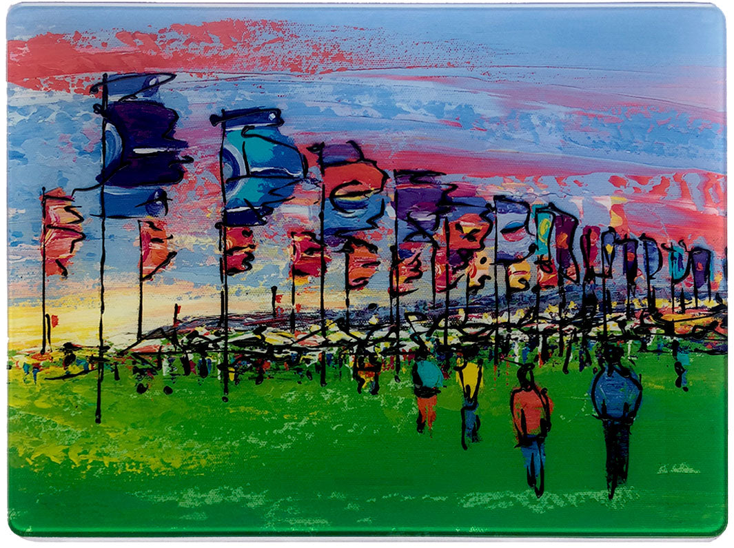 Glass platter / worktop saver with colourful artwork of sunset at Glastonbury Festival with flags by artist Hannah van Bergen