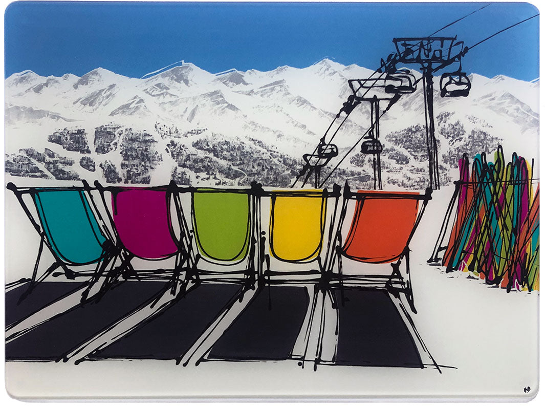 Glass platter / worktop saver with artwork of 5 deckchairs in the snow with mountain backdrop, skis and chair lift by artist Hannah van Bergen