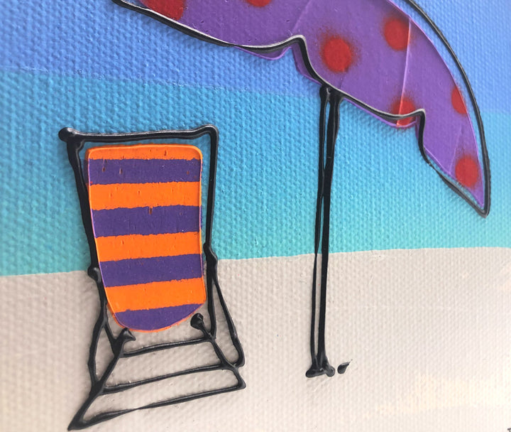 Close up of original textured mini canvas painting of a colourful deckchair and parasol on the beach with blue sky by artist Hannah van Bergen