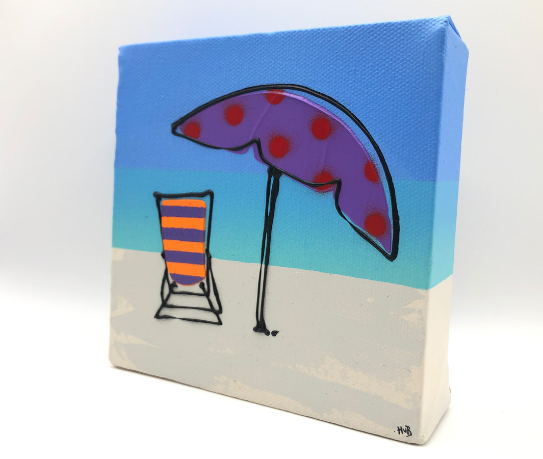 Original textured mini canvas painting of a colourful deckchair and parasol on the beach with blue sky by artist Hannah van Bergen