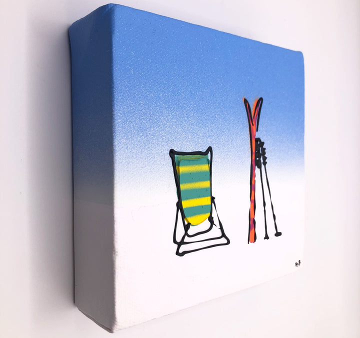 Original textured mini canvas painting of a deckchair, skis and poles in the snow with blue sky by artist Hannah van Bergen