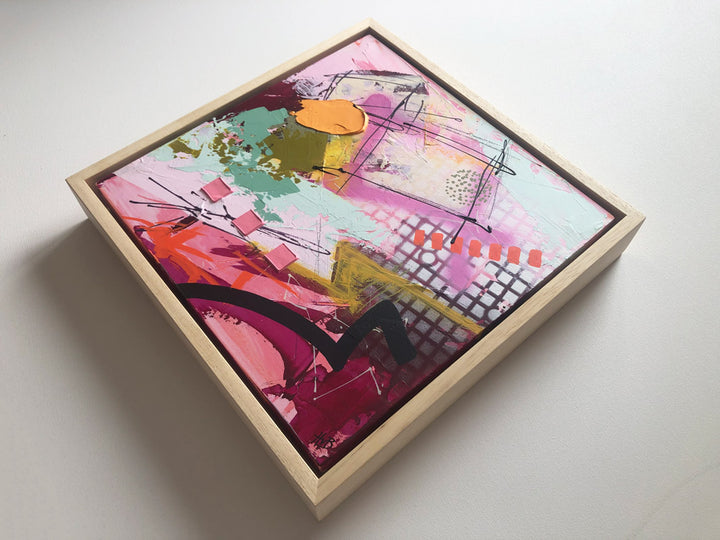 Original textured industrial abstract painting with pinks, maroon, raspberry, peach colour, mint, mustard and black by artist Hannah van Bergen. Spray paint and thick paint strokes. Framed in natural wood frame.