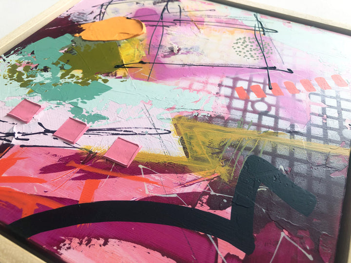 Close-up of original textured industrial abstract painting with pinks, maroon, raspberry, peach colour, mint, mustard and black by artist Hannah van Bergen. Spray paint and thick paint strokes. Framed in natural wood frame.