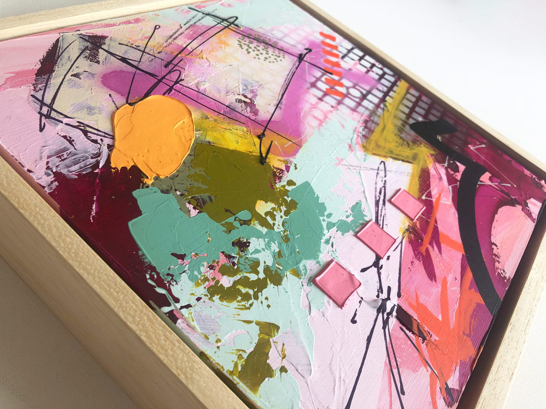 Original textured industrial abstract painting with pinks, maroon, raspberry, peach colour, mint, mustard and black by artist Hannah van Bergen. Spray paint and thick paint strokes. Framed in natural wood frame.