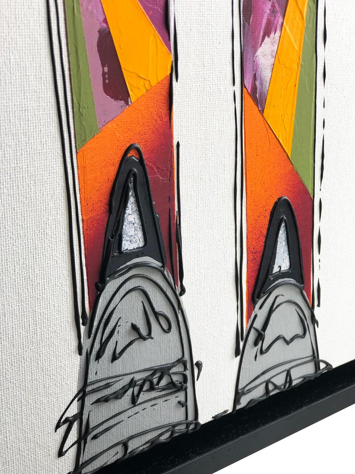 Close-up detail of texture on painting of colourful skis on white background framed in a black frame by artist Hannah van Bergen