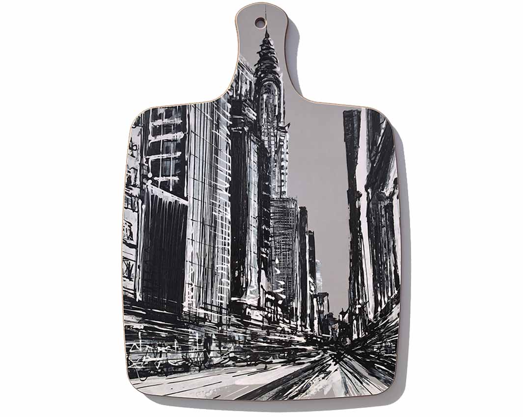 Chopping board with handle featuring black and white New York street scene including the Chrysler Building by artist Hannah van Bergen